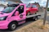 red car on the pink removal truck